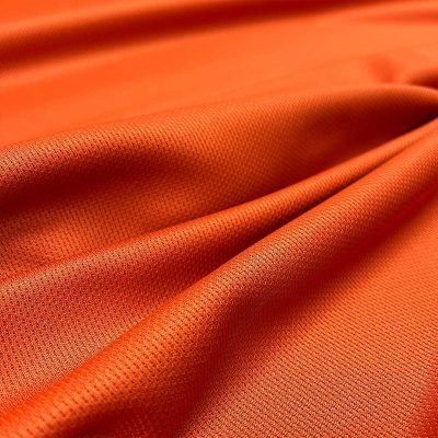 Tessuto tecnico da abbigliamento leggermente elasticizzato arancio vivo 2