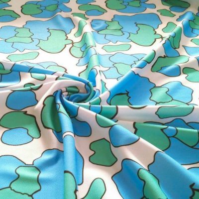 Tessuto Abbigliamento fantasia astratta bianco/turchese Alt.145 cm