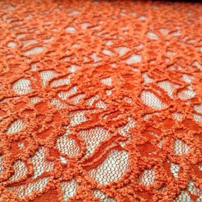 Tessuto in pizzo con rose in rilievo colore arancione al metro