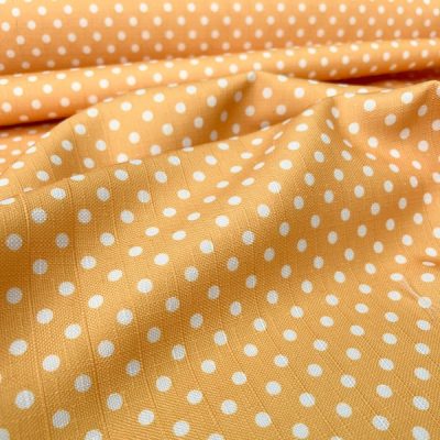 Tessuto multiuso con pois bianchi su giallo ambra 1