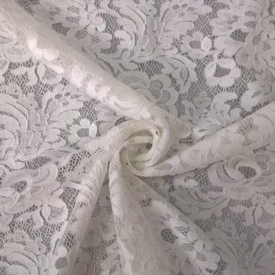 Tessuto per abito in pizzo elasticizzato motivo floreale bianco 1